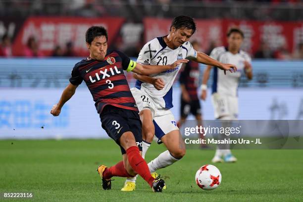 Gen Shoji of Kashima Antlers and Shun Nagasawa of Gamba Osaka compete for the ball during the J.League J1 match between Kashima Antlers and Gamba...