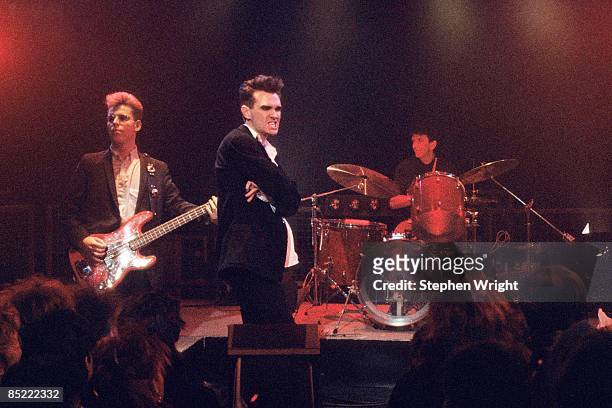 Road Show Photo of Mike JOYCE and Andy ROURKE and MORRISSEY and The Smiths, L-R: Andy Rourke, Morrissey, Mike Joyce performing 'The Headmaster...