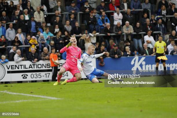 Goalkeeper Isak Pettersson of Halmstad BK screams as he is tackled by Kalle Holmberg of IFK Norrkoping at Orjans Vall on September 23, 2017 in...