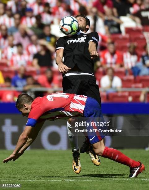 Atletico Madrid's midfielder from Spain Gabi vies with Sevilla's midfielder from Italy Franco Vazquez during the Spanish league football match Club...