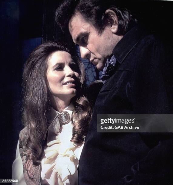 Photo of June CARTER and Johnny CASH, Johnny Cash and wife June Carter Cash performing on stage
