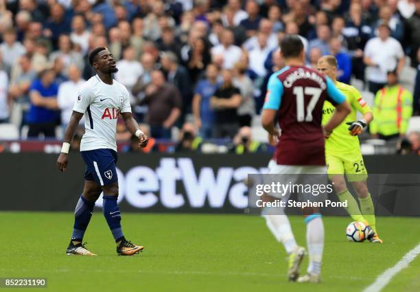 Serge Aurier of Tottenham Hotspur walks off dejected after being sent off during the Premier League match between West Ham United and Tottenham...