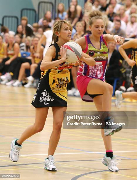 Samia Ghadie from Coronation Street shields the ball from Eden Taylor-Draper from Emmerdale during a charity netball match between Coronation Street...
