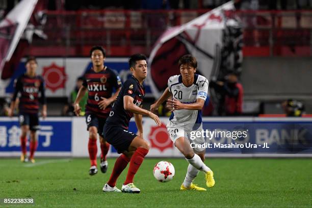 Naomichi Ueda of Kashima Antlers and Shun Nagasawa of Gamba Osaka compete for the ball during the J.League J1 match between Kashima Antlers and Gamba...