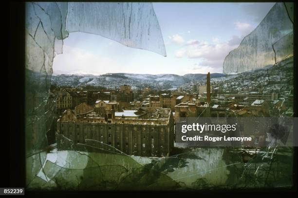 Broken window sits in the destroyed parliament building March 5, 1996 in Sarajevo, Bosnia-Herzegovina. The city is reopening its businesses,...