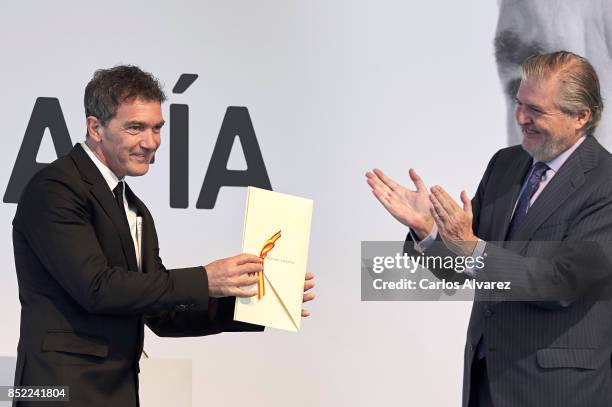 Spanish actor Antonio Banderas receives from Spanish Minister of Culture Inigo Mendez de Vigo the National Cinema Award during the 65th San Sebastian...
