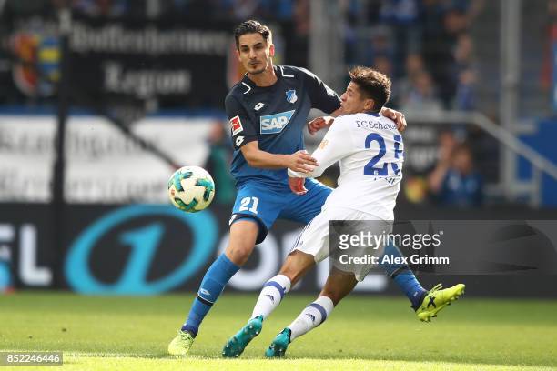 Benjamin Huebner of Hoffenheim fights for the ball with Amine Harit of Schalke during the Bundesliga match between TSG 1899 Hoffenheim and FC Schalke...