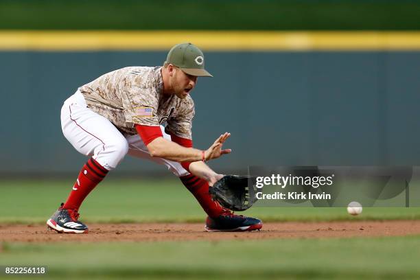 Patrick Kivlehan of the Cincinnati Reds fields a ground ball during the game against the Cincinnati Reds at Great American Ball Park on September 19,...