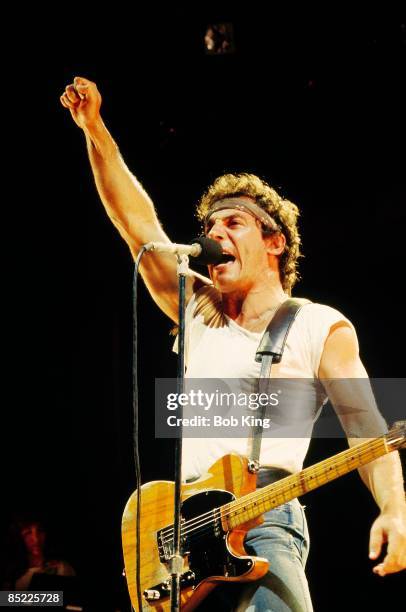 Photo of Bruce SPRINGSTEEN; performing live onstage, with fist in the air, on Born In The USA tour