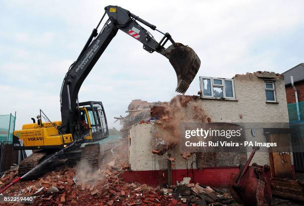 Demolition work begins on Mick and Mairead Philpott's old family home on Victory Road, Derby, where the two parents set a deadly fire which killed...