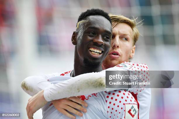 Jean-Kevin Augustin of Leipzig celebrates after he scored his team first goal to make it 1:0 with Emil Forsberg of Leipzig during the Bundesliga...