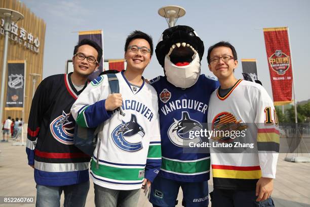 Vancouver Canucks mascot Fin poses with fans before the pre-season game between the Los Angeles Kings and the Vancouver Canucks at Wukesong Arena on...