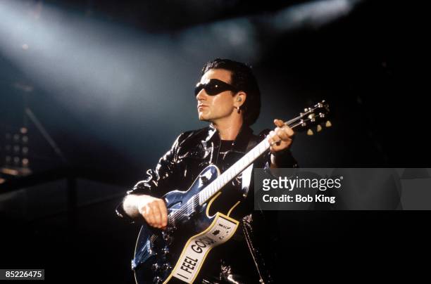 Photo of BONO and U2; Bono performing live onstage at the Aussie Stadium on the Zoo TV tour, Zoomerang leg, playing guitar, wearing sunglasses