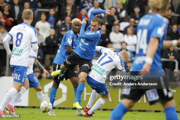 Aboubakar Keita and Pontus Silfwer of Halmstad BK compete with Kalle Holmberg for the ball at Orjans Vall on September 23, 2017 in Halmstad, Sweden.