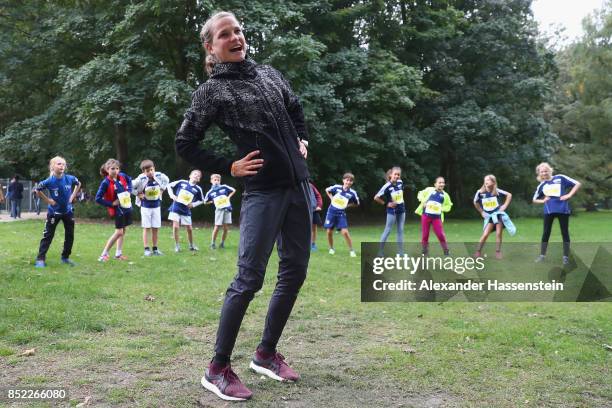 Lisa Hahner warms-up with starters for the school mini Marathon ahead of the BMW Berlin Marathon 2017 on September 23, 2017 in Berlin, Germany.