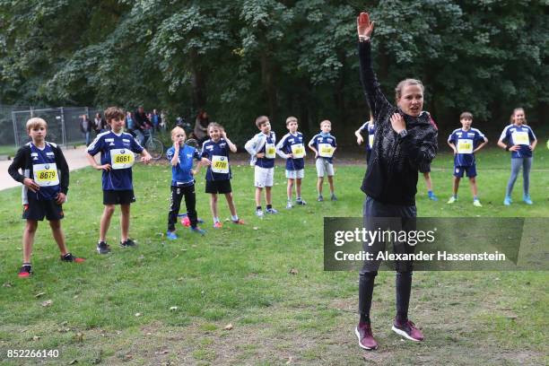 Lisa Hahner warms-up with starters for the school mini Marathon ahead of the BMW Berlin Marathon 2017 on September 23, 2017 in Berlin, Germany.