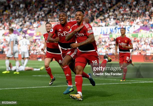 Andre Gray of Watford celerbates scoring the opening goal with his team mate Andre Carrilo during the Premier League match between Swansea City and...