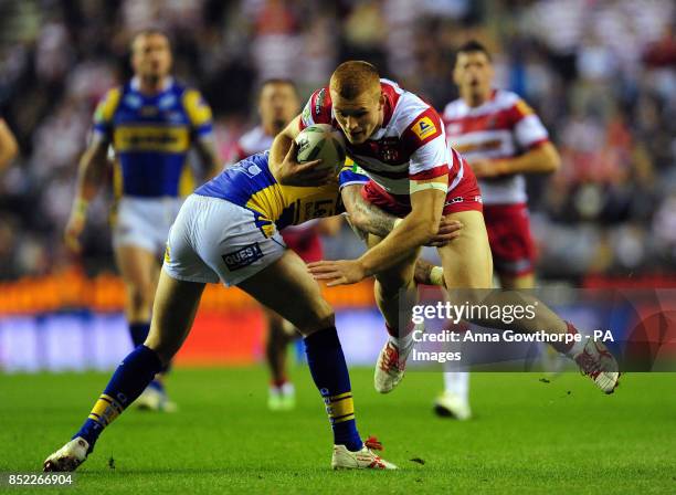 Wigan Warriors' Jack Hughes is tackled by Leeds Rhinos' Zak Hardaker during the Super League Semi-Final match at the DW Stadium, Wigan.