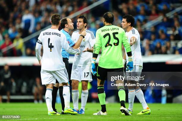 Real Madrid's Sergio Ramos Alvaro Arbeloa goalkeeper Diego Lopez and Pepe surround referee Mateu Lahoz