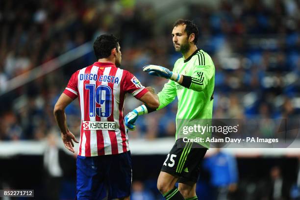 Atletico Madrid's Diego Costa argues with Real Madrid goalkeeper Diego Lopez