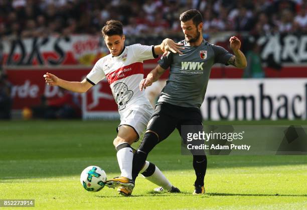 Marcel Heller of Augsburg challenges Josip Brekalo of VfB Stuttgart during the Bundesliga match between VfB Stuttgart and FC Augsburg at...