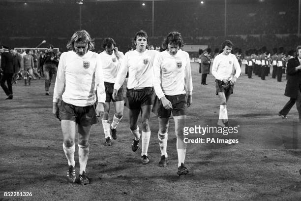 Dejected England players Tony Currie, Paul Madeley, Martin Peters and Mike Channon leave the pitch after a crucial World Cup qualifying match against...