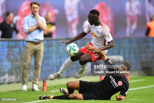 Coach Niko Kovac of Frankfurt looks on as Jean-Kevin Augustin of Leipzig and Simon Falette of Frankfurt fight for the ball during the Bundesliga...