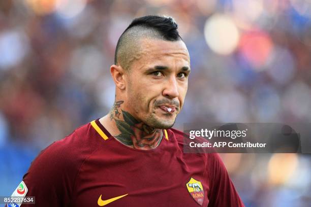 Roma's midfielder from Belgium Radja Nainggolan spits during the Italian Serie A football match AS Roma vs Udinese on September 23, 2017 at the...