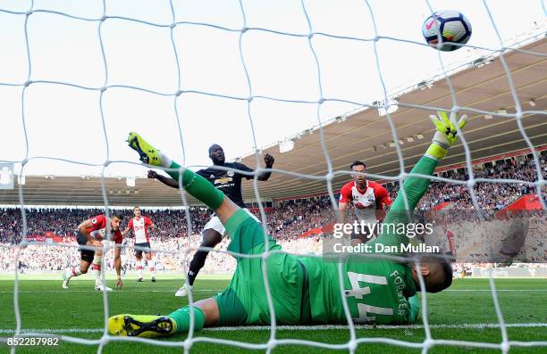 Romelu Lukaku of Manchester United scores his sides first goal past Fraser Forster of Southampton during the Premier League match between Southampton...