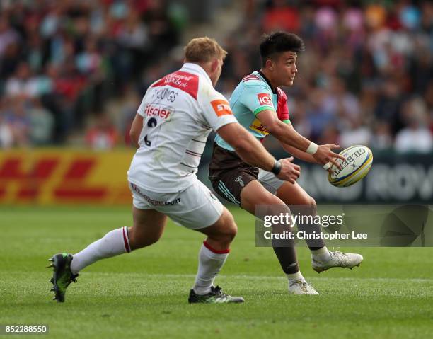 Marcus Smith of Harlequins passes the ball as Tom Youngs of Leicester Tigers gets close during the Aviva Premiership match between Harlequins and...