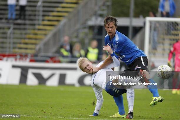 Kalle Holmberg of IFK Norrkoping is taken down by Fredrik Liverstam of Halmstad BK at Orjans Vall on September 23, 2017 in Halmstad, Sweden.