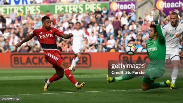 Watford striker Andre Gray scores the opening goal during the Premier League match between Swansea City and Watford at Liberty Stadium on September...