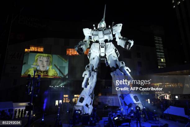 The new full-size standing statue RX-0 Unicorn Gundam from the Mobile Suit Gundam UC anime is unveiled at a press preview in Tokyo on September 23,...
