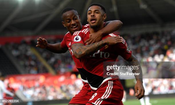 Watford striker Andre Gray celebrates with Andre Carrillo after scoring the opening goal during the Premier League match between Swansea City and...