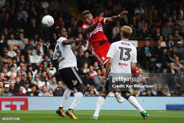 Brett Assombalonga of Middlesbrough rises above Ryan Sessegnon and Tim Ream of Fulham during the Sky Bet Championship match between Fulham and...