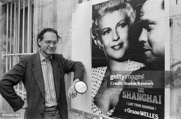 Michel Boujut stands next to a poster advertising Orson Welles' 1947 film, The Lady from Shanghai. Boujut is a French film and music critic, whose...