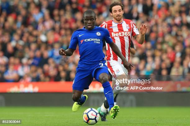 Chelsea's French midfielder N'Golo Kante vies with Stoke City's Welsh midfielder Joe Allen during the English Premier League football match between...