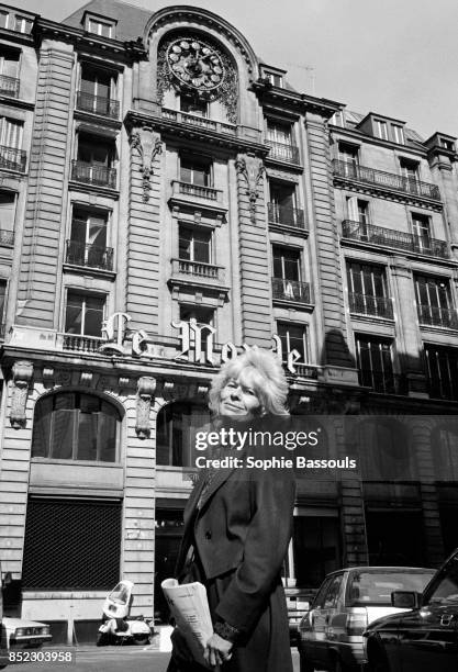 French journalist and writer Claude Sarraute stands across the street from the offices of the newspaper Le Monde. Sarraute wrote for Le Monde for...