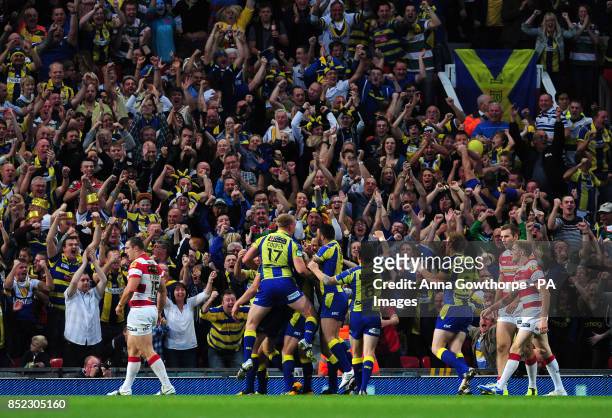 Warrington Wolves players celebrate as Ben Westwood scores a try during the Super League Grand Final at Old Trafford, Manchester.