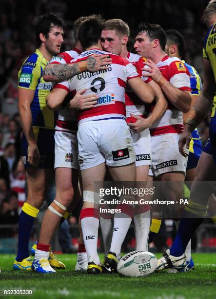 Wigan Warriors' Darrell Goulding is congratulated by Sam Tomkins after scoring a try during the Super League Grand Final at Old Trafford, Manchester.