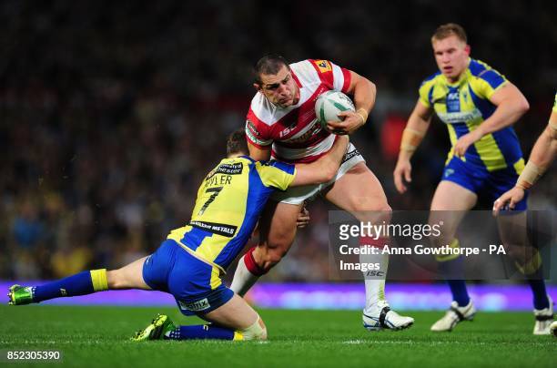 Wigan Warriors' Ben Flower is tackled by Warrington Wolves' Richard Myler during the Super League Grand Final at Old Trafford, Manchester.