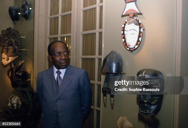 Leopold Senghor looks at a collection of masks on display in his Paris home. Formerly the president of the Republic of Sengeal, Senghor, an avid...