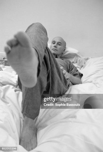 French writer Gabriel Matzneff shows the bottom of his foot as he reclines on a bed. Matzneff is a novelist, essayist, poet, and writer for various...