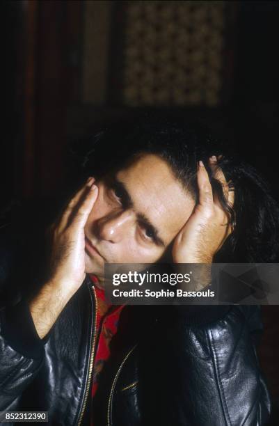 Pakistani-British writer Hanif Kureishi turns his head to the side. Kureishi is known for his screenplays and novels.