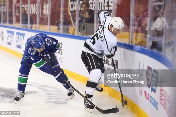Chris Tanev of Vancouver Canucks skates against Jonny Brodzinski of Los Angeles Kings during the pre-season game between the Los Angeles Kings and...