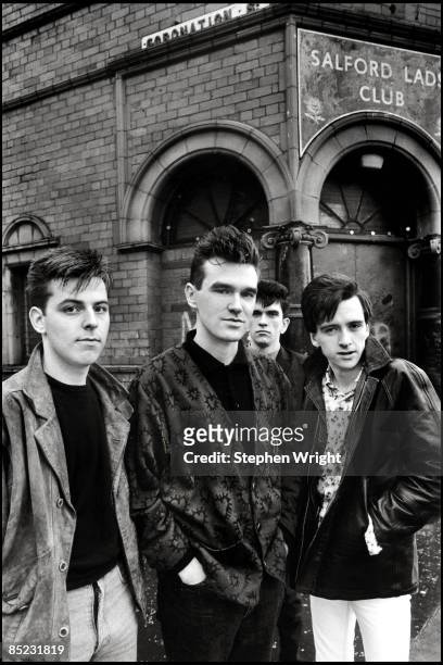 Photo of The Smiths; L-R: Andy Rourke, Morrissey, Mike Joyce, Johnny Marr - posed, group shot - outside Salford Lads Club, Queen Is Dead sessions