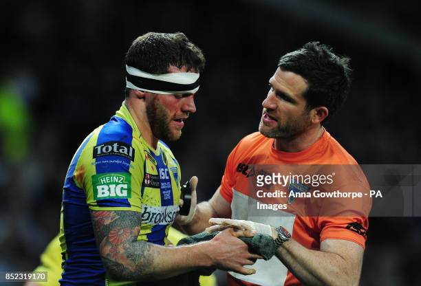 Warrington Wolves' Simon Grix receives treatment during the Super League Grand Final at Old Trafford, Manchester.