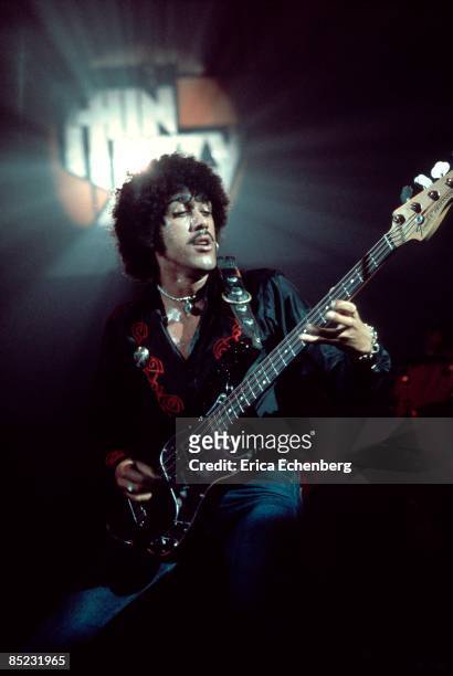 Photo of Phil LYNOTT and THIN LIZZY; Phil Lynott performing live onstage, playing Fender Precision bass