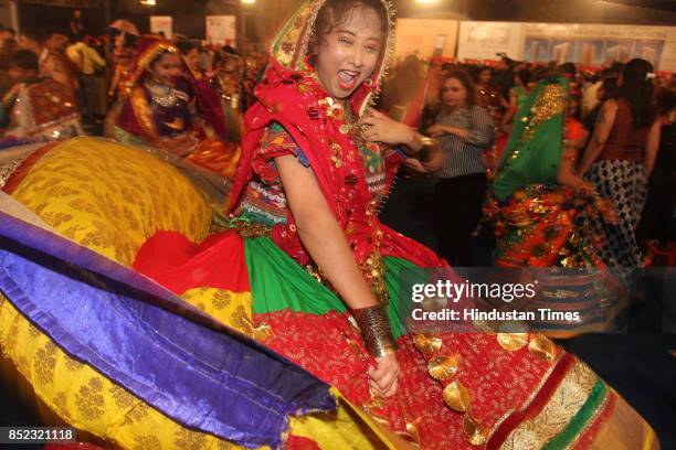 Women perform Dandiya dance at "Thane Raas Rang Navratri Festival" during Navratri festival at Modella Mill Compound, on September 22, 2017 in...