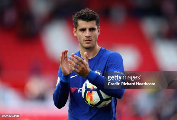 Alvaro Morata of Chelsea celebrates his team's 4-0 victory and his hat trick with the match ball after the Premier League match between Stoke City...
